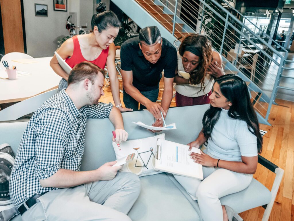 pexels-photo-7688169-7688169 Dynamic group of colleagues brainstorming and working together in an office setting.