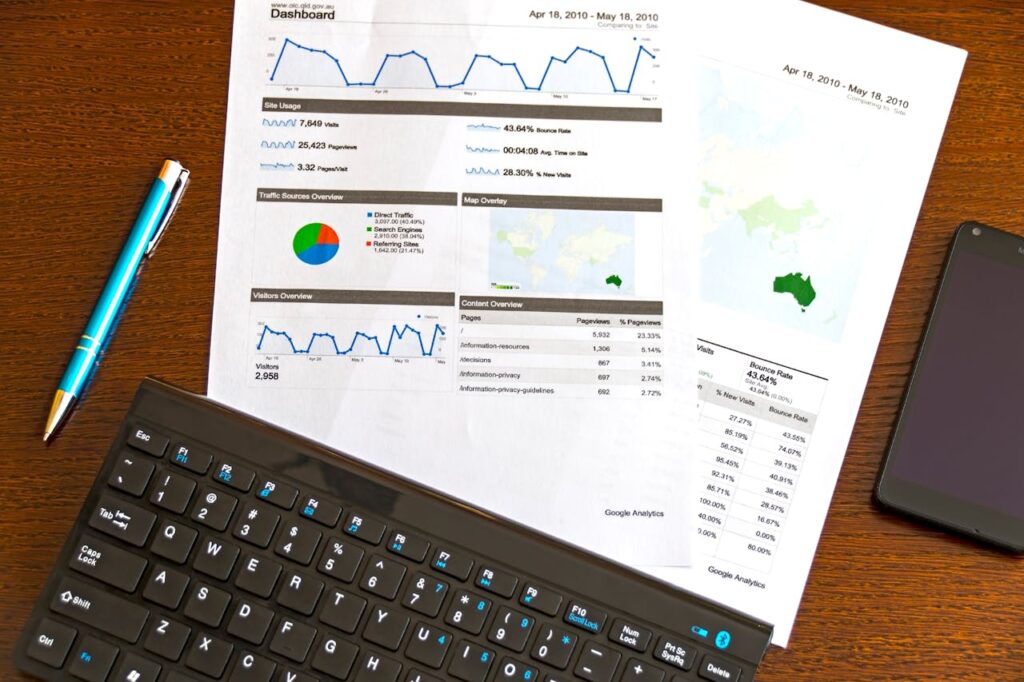 pexels-photo-95916 Flatlay of a business analytics report, keyboard, pen, and smartphone on a wooden desk.